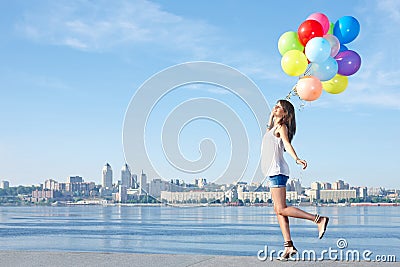 Happy young woman with colorful balloons