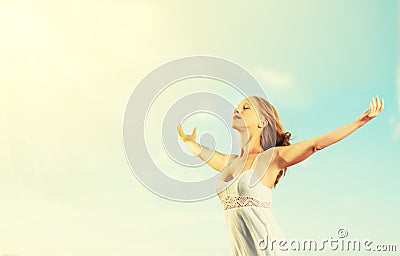 Happy young woman open her arms to the sky