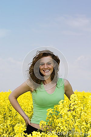 Happy young woman in rape flower field