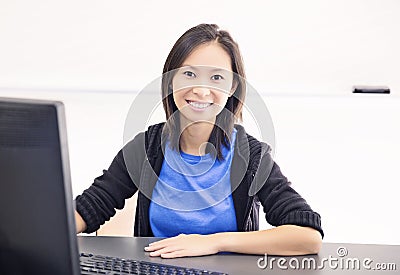 Happy young woman using computer