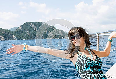 Happy young woman on yacht in the sea