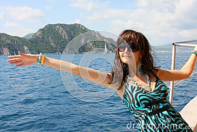 Happy young woman on yacht in the sea