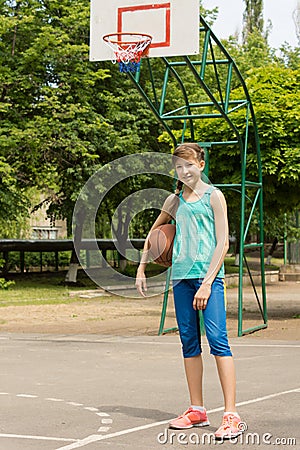 Healthy active teenage girl on a basketball court