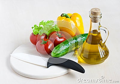 Healthy food still life with white ceramic knife
