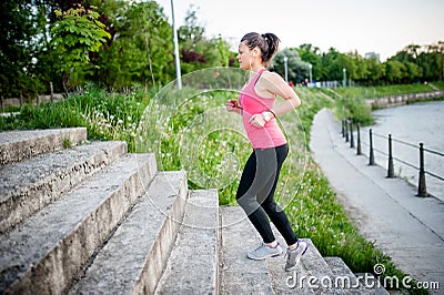 Healthy lifestyle sports woman running on street stairs along ri