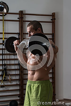 Healthy Man Working Out Biceps In A Health Club