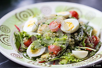 Healthy quinoa salad with tomatoes, avocados, eggs, herbs