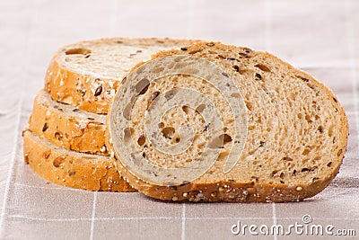 Healthy whole grain sliced bread with sunflower seeds on brown n