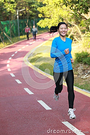 Healthy woman running at park