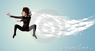 Healthy young woman jumping with feathers around her