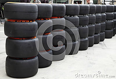 Heap of Formula 1 vehicle tyres in front of Pit stop garage