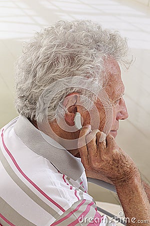 Hearing aid on senior man