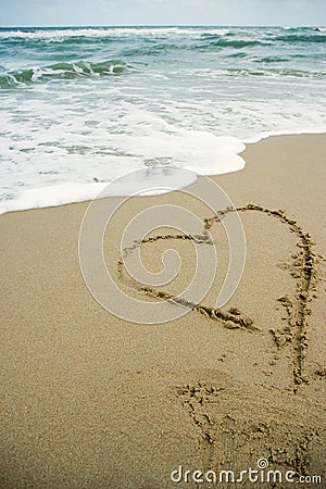 Heart drawing on the sand beach