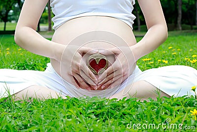 Heart with pregnant mom in the garden