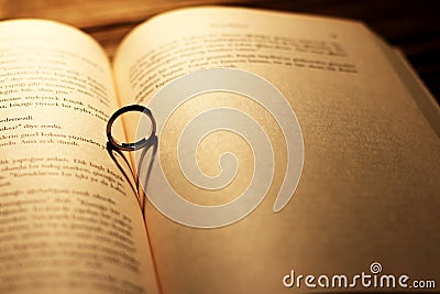 Heart shadow with ring on a book middle - write your text