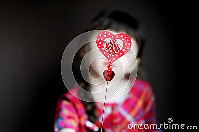 Heart shaped toy in child s hands