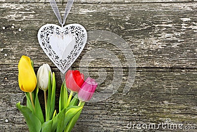 Heart and tulips on Valentines Day on wood background