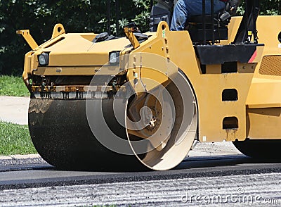 Heavy machinery asphalt roller with man