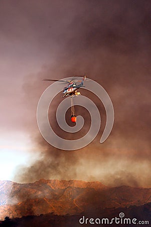 Helicopter with fire bucket, Spain.