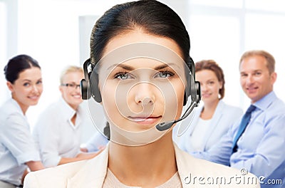 Helpline operator with headphones in call centre