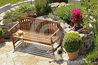 Herb garden and bench with little apple tree