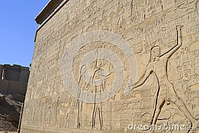 Hieroglyphic carvings on an egyptian temple wall