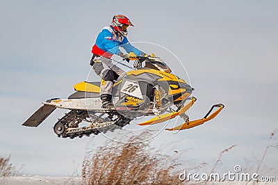 High jump of sportsman on snowmobile