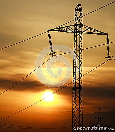 High power electric line towers at dramatic sunset