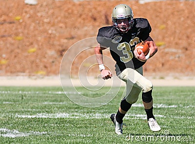 High School Football Player Running with the Ball During a Game