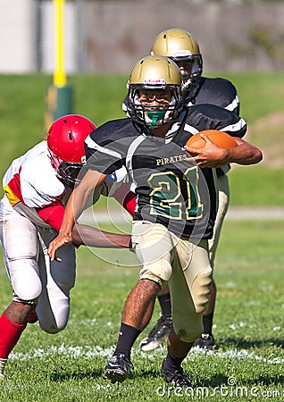 High School Football Player Running with the Ball