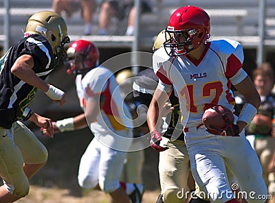 High School Football Player Running with the Ball