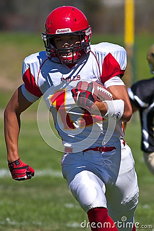 High School Football Player Running with the Ball