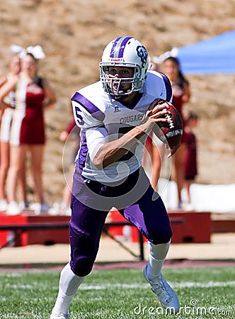 High School Football Player Running with the Ball