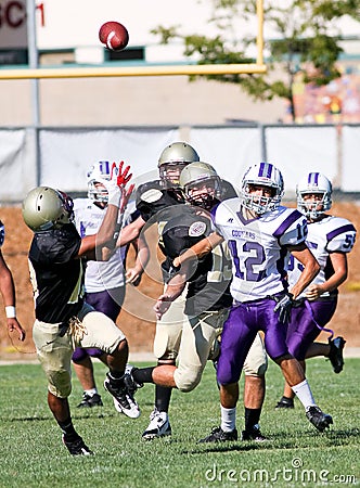 High School Football Players in Action During a Game