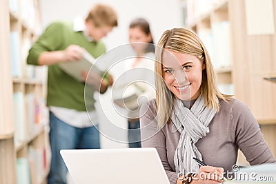 High school library - happy student with laptop