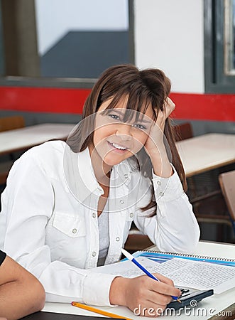 High School Student Leaning At Desk