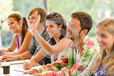 High-school student raising her hand in class