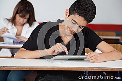 High School Student Using Digital Tablet At Desk
