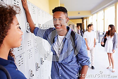 High School Students Standing By Lockers Talking