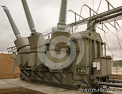 High voltage transformer tank and turrets and grey sky