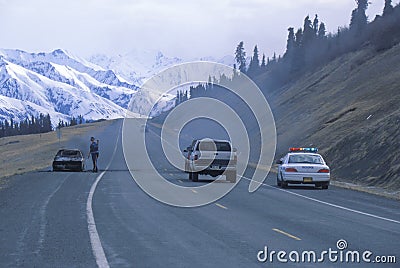 Highway patrolman and car on fire