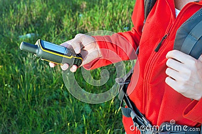 Hiker young woman holding in her hand GPS