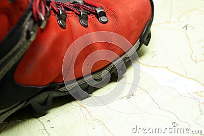 Hiking shoes on map of mountains