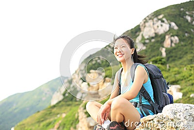 Hiking woman woman hiker sit on seaside mountain rock