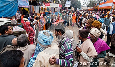 Hindu devotees qued up for food at transit camp
