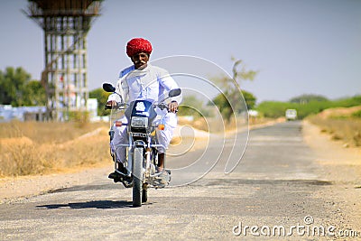 Hindu old man on a motorbike