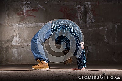 Hip hop dancer in modern style over brick wall