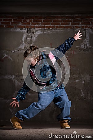 Hip hop dancer in modern style over brick wall