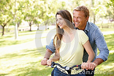 Hispanic Couple outdoors in park with bike