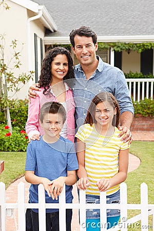 Hispanic family standing outside home